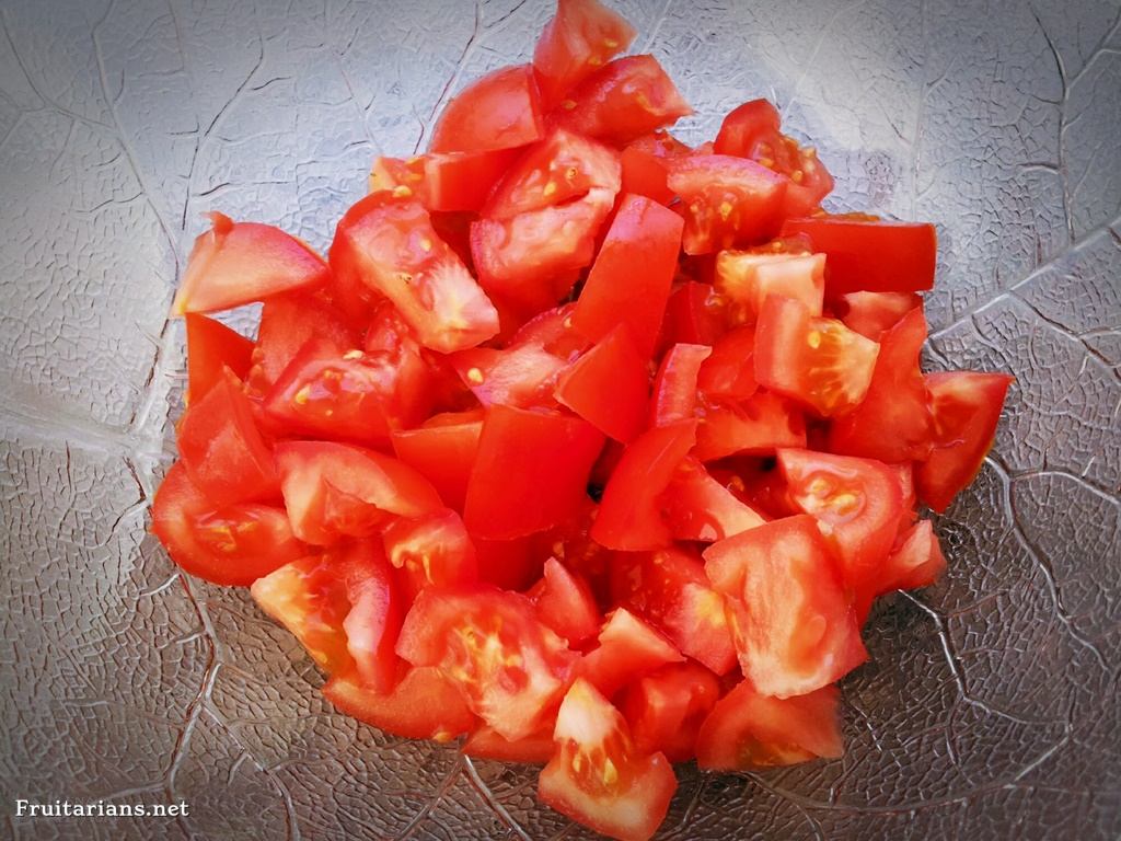 Cut tomatoes in small pieces. I cut tomatoes by the old tradition, holding one in my left hand over the bowl.